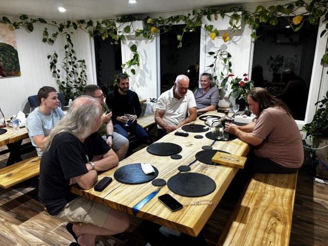 Casual gathering around the table after the joint dinner