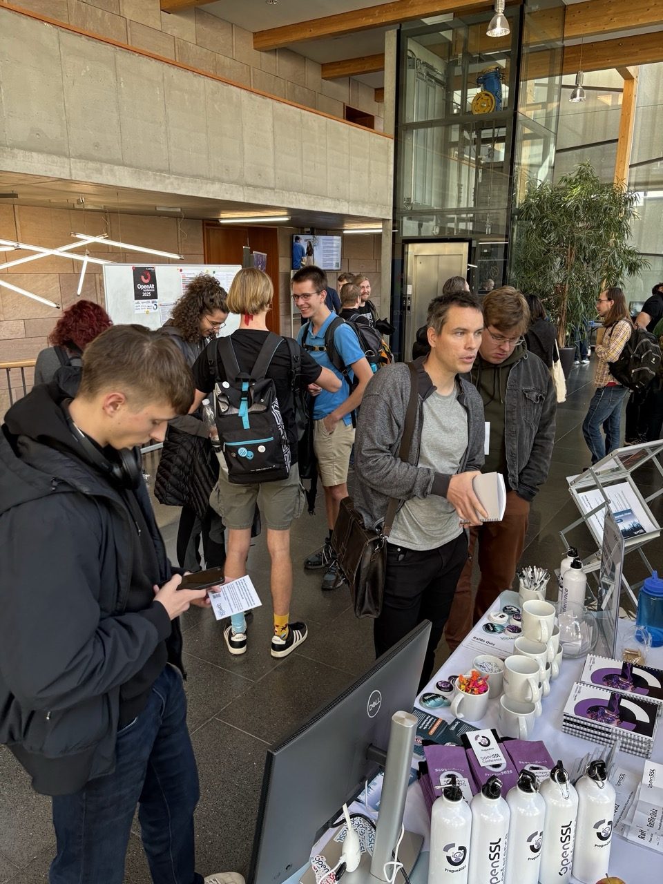 Attendees engaging with the OpenSSL Corporation team at the booth