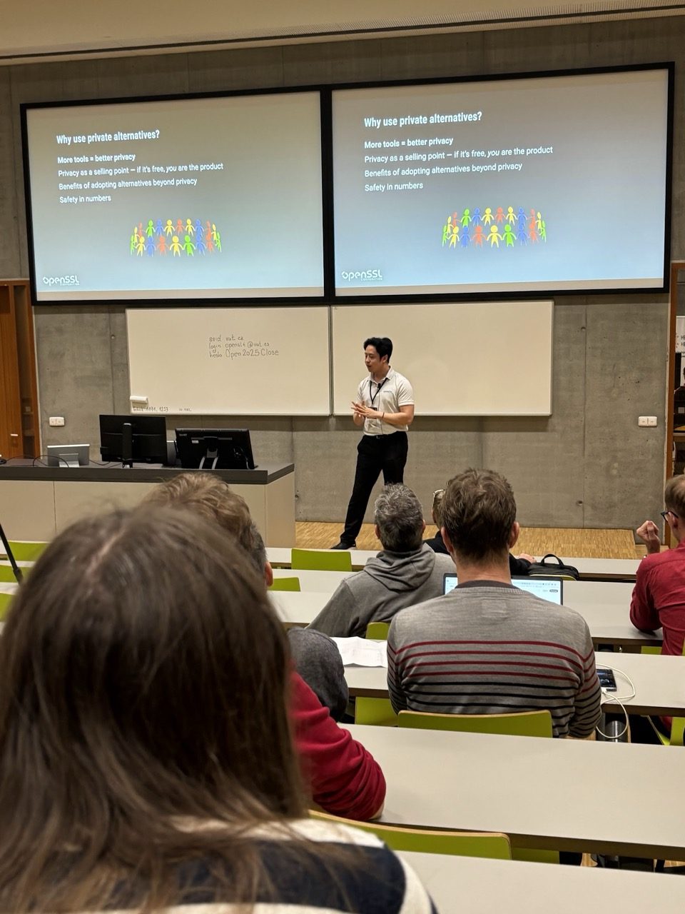 Andrew Dinh presenting a talk to attendees at OpenAlt 2025