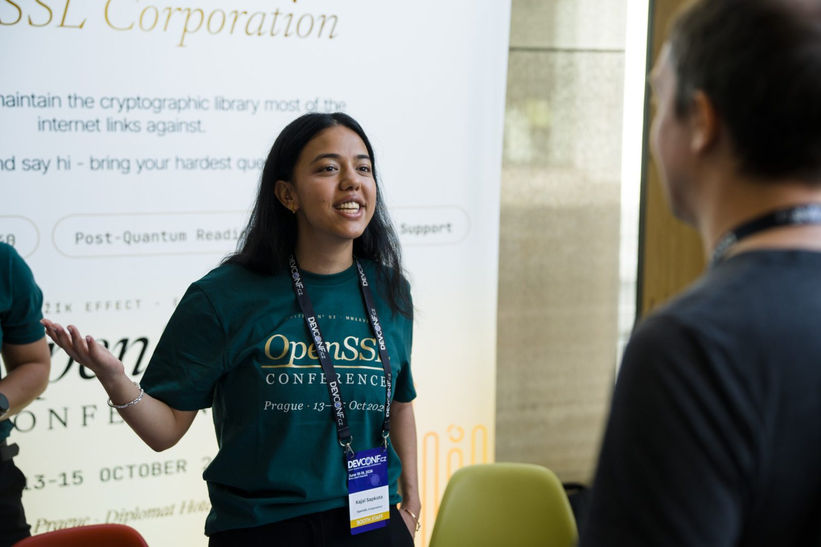 A booth staffer mid-conversation with an attendee
