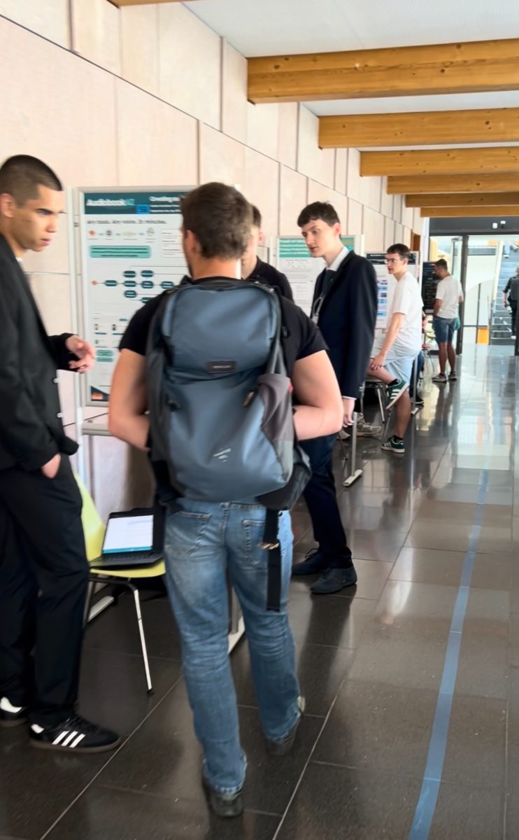 Students and visitors
                                        in conversation at the Excel@FIT poster session