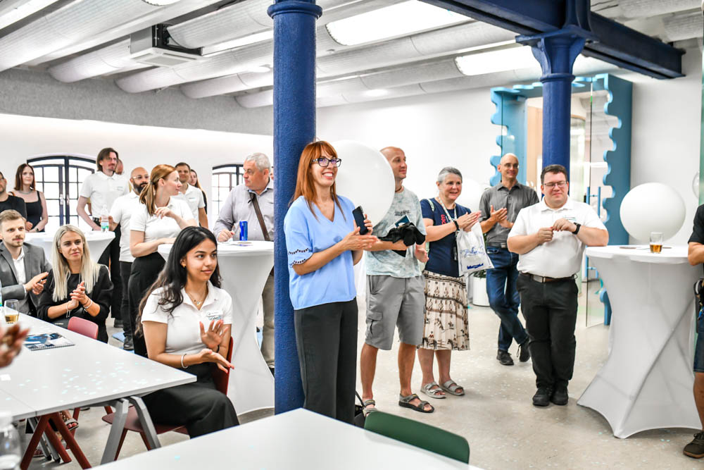 Visitors at the official opening are listening to a presentation by Tim Hudson, President of the OpenSSL Corporation